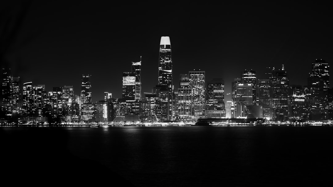 grayscale photo of city skyline during night time