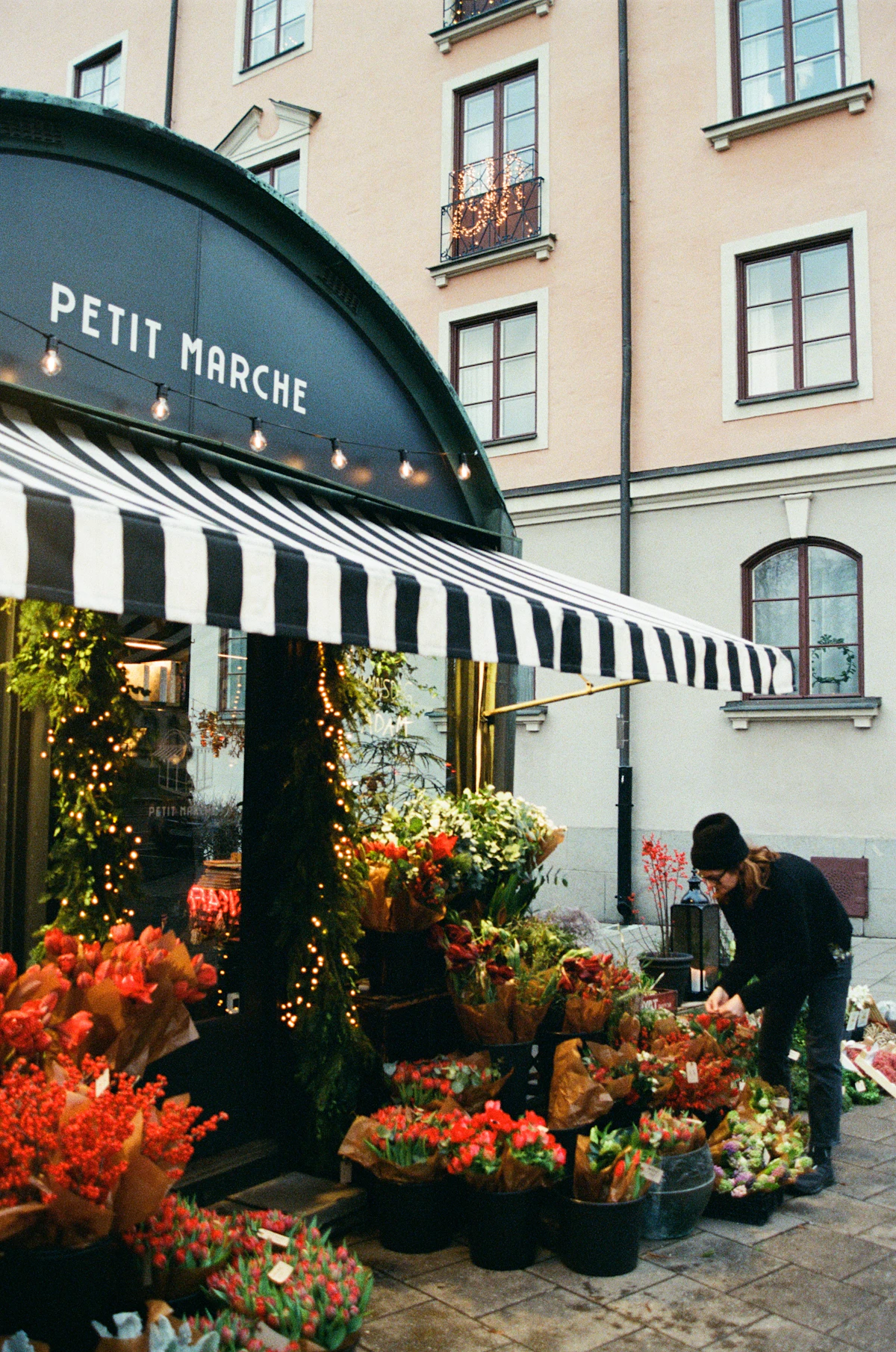A florist arranging flowers outside her independent shop