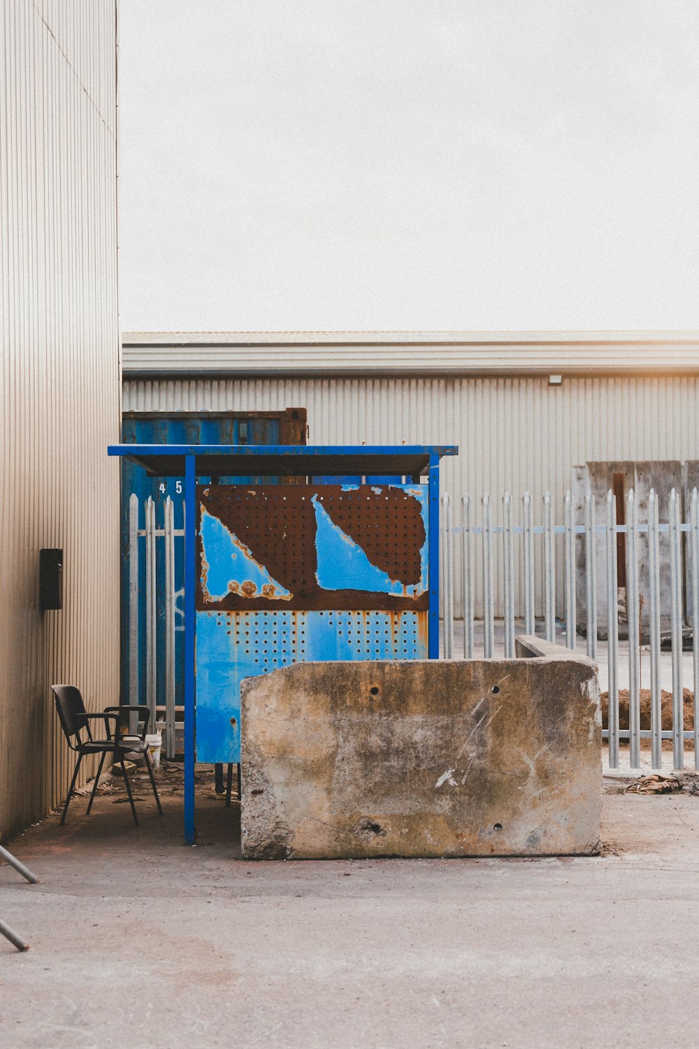 blue metal gate near white building