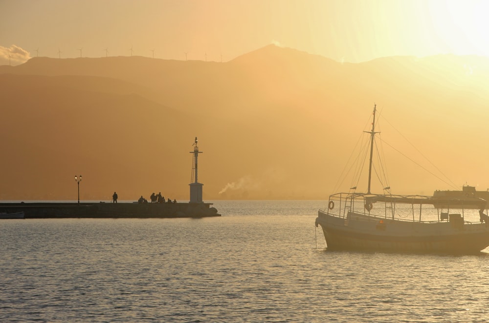 white and blue boat on sea during daytime