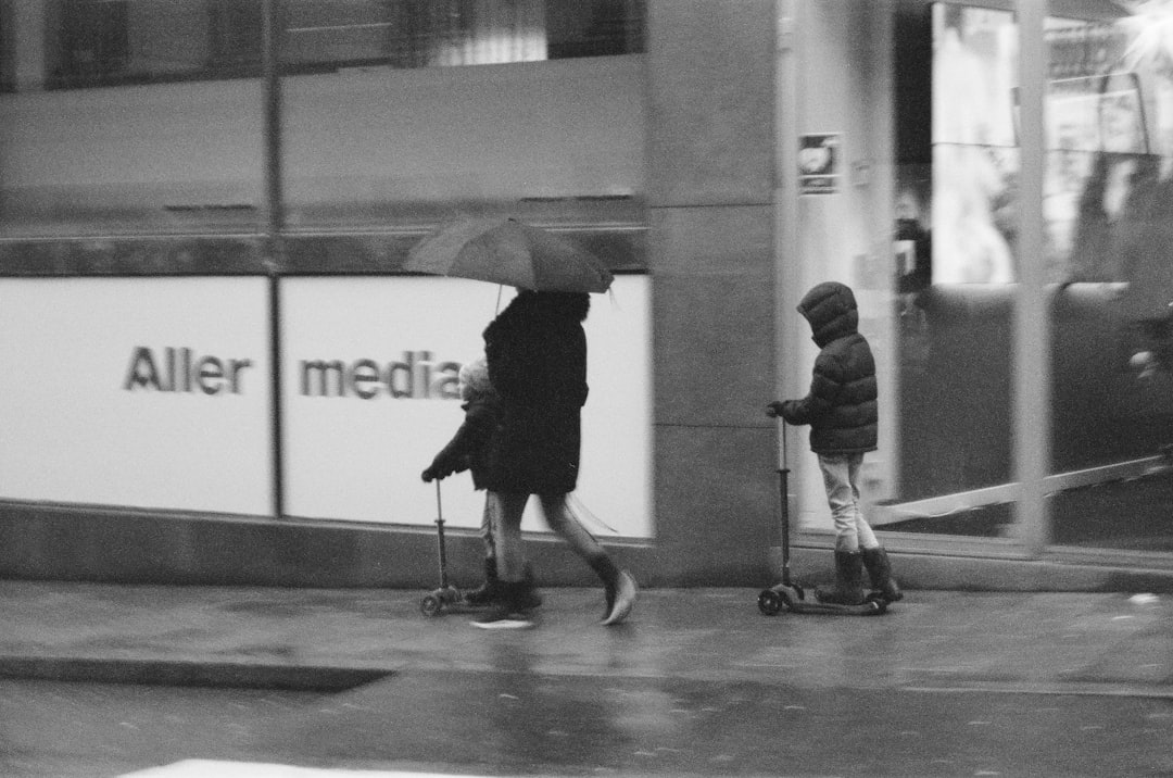 grayscale photo of 2 women walking on hallway