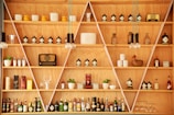 clear glass bottles on brown wooden shelf