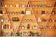 clear glass bottles on brown wooden shelf
