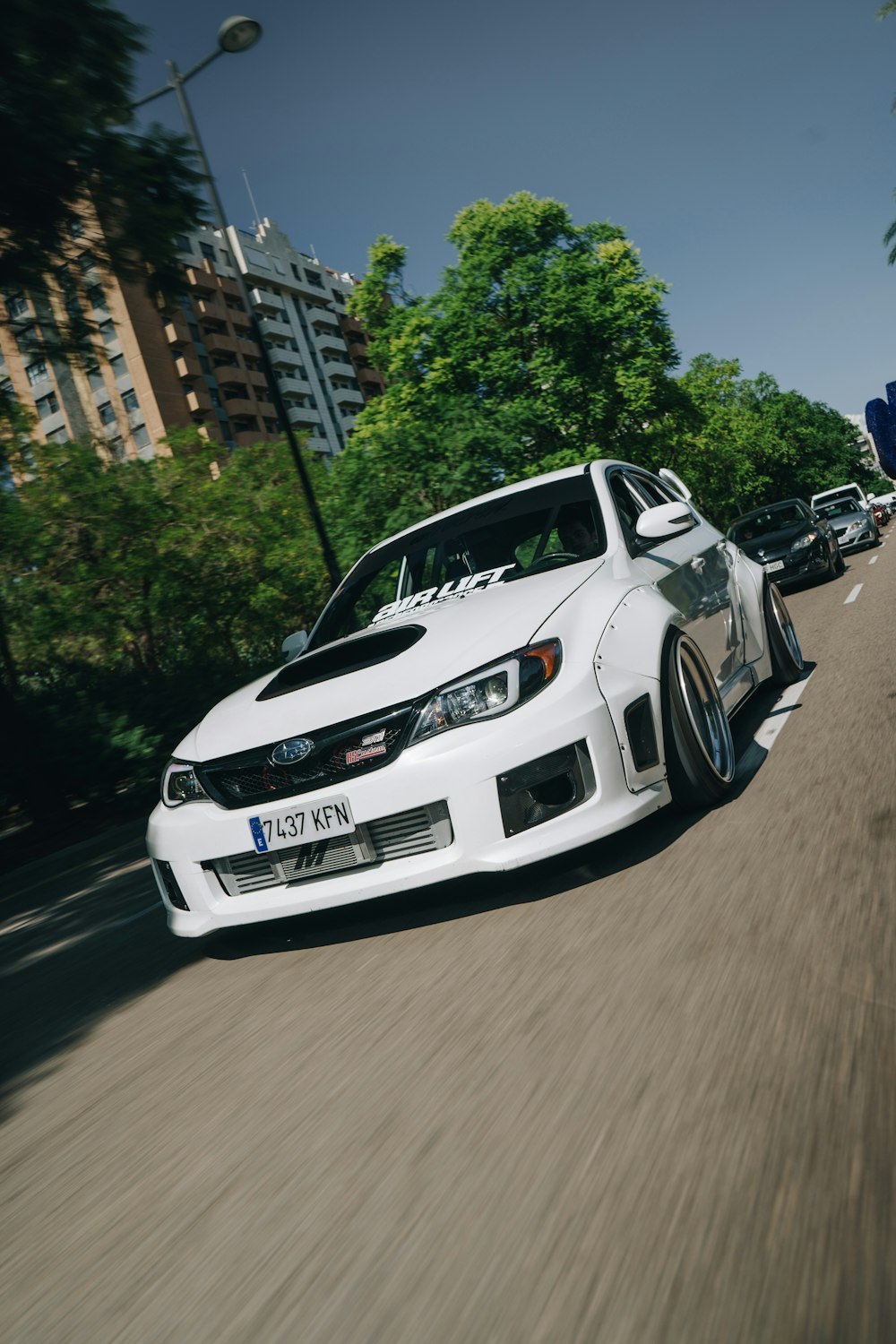 white bmw m 3 on road during daytime