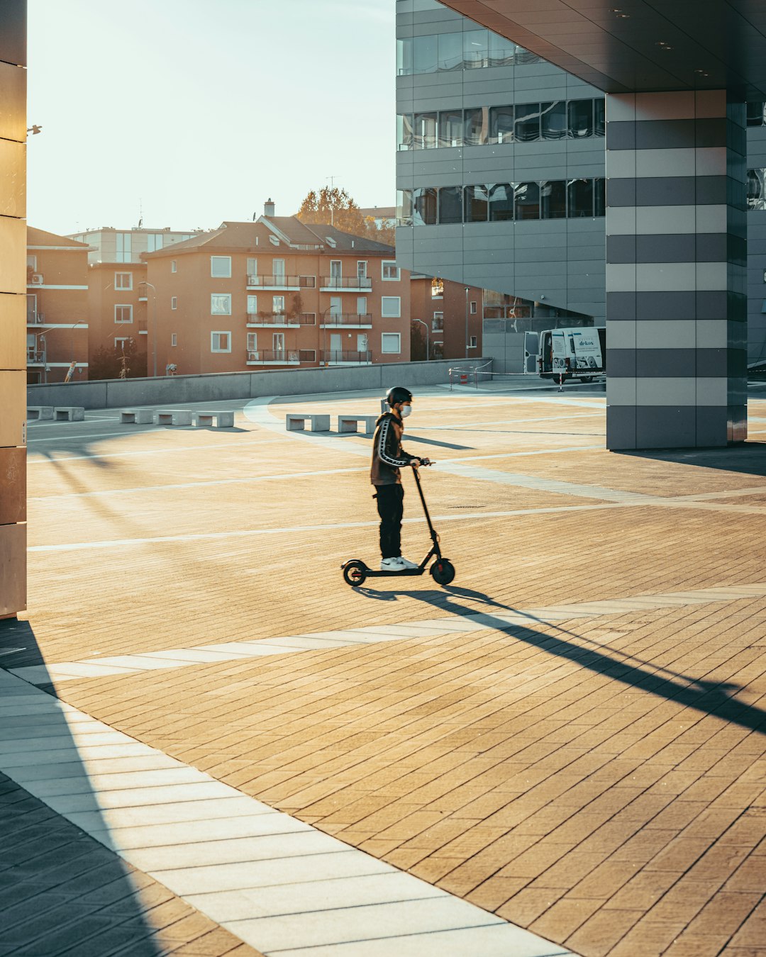 man in black jacket riding on bicycle on road during daytime