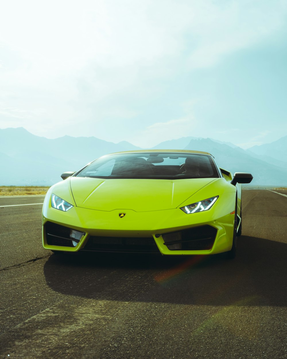 yellow lamborghini aventador on road during daytime