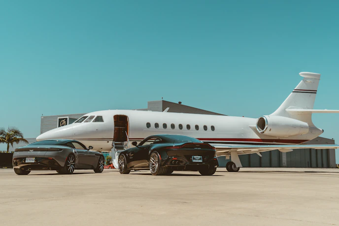 A luxurious limousine parked at an airport terminal, ready for passengers.