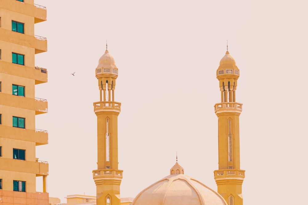 white and gold mosque under white sky during daytime