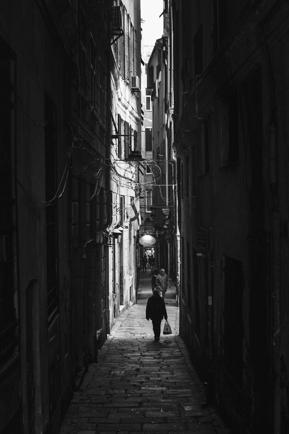 grayscale photo of woman walking on hallway