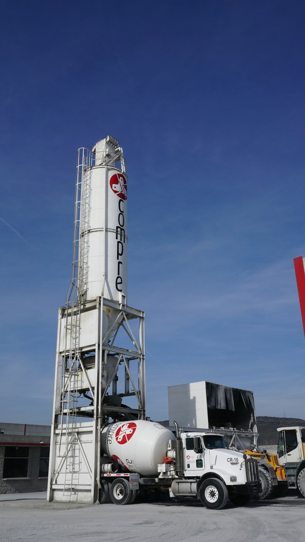 white and red tower under blue sky during daytime