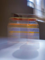 Close-up of a serum bottle with soft natural light highlighting its texture.