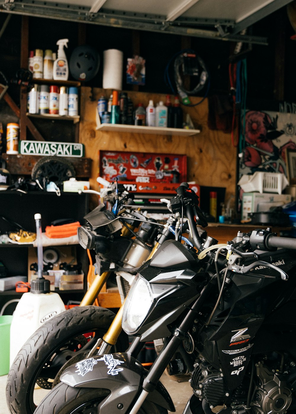 black and white motorcycle parked beside brown wooden table