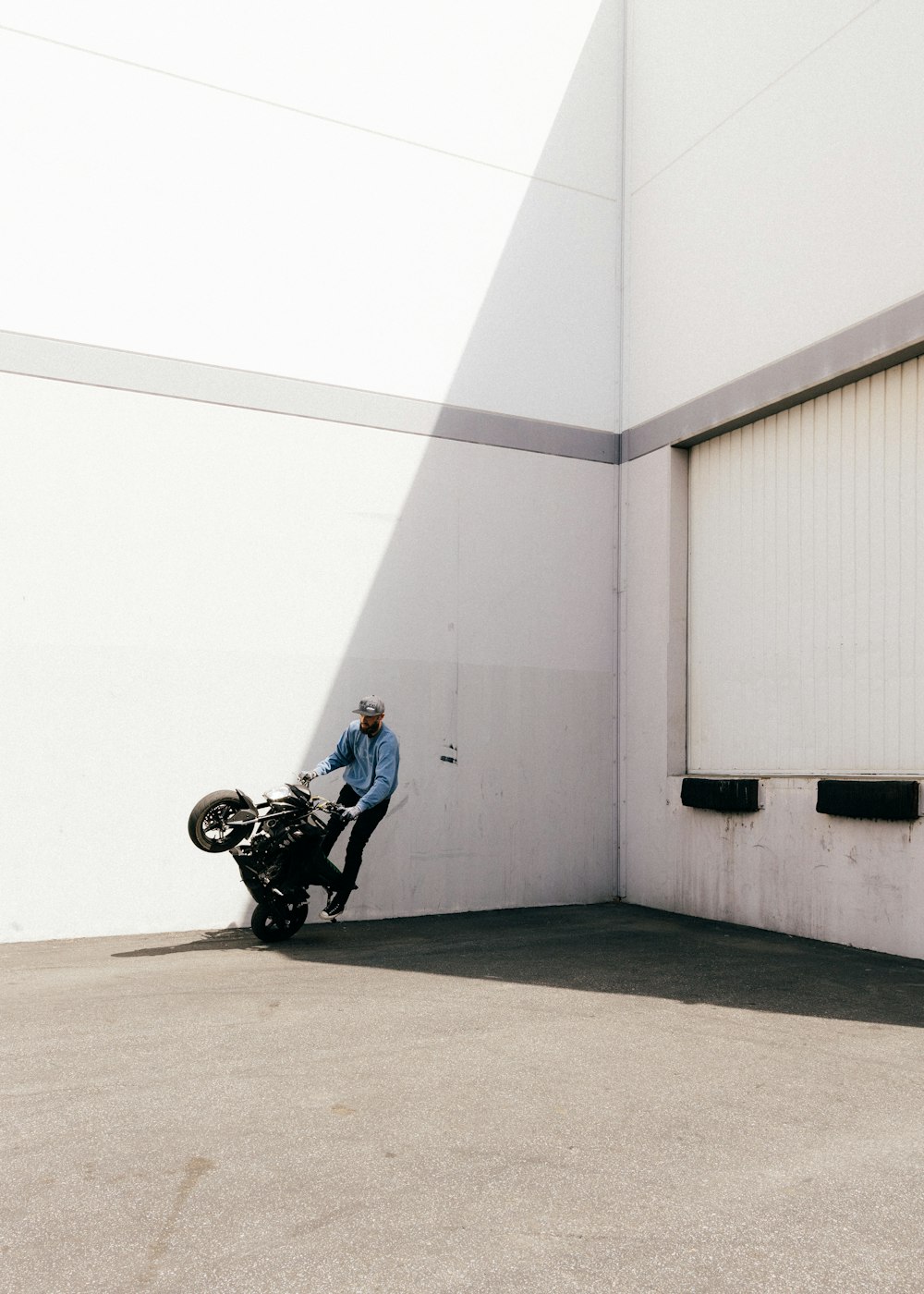 man in blue shirt and black pants riding on black motorcycle