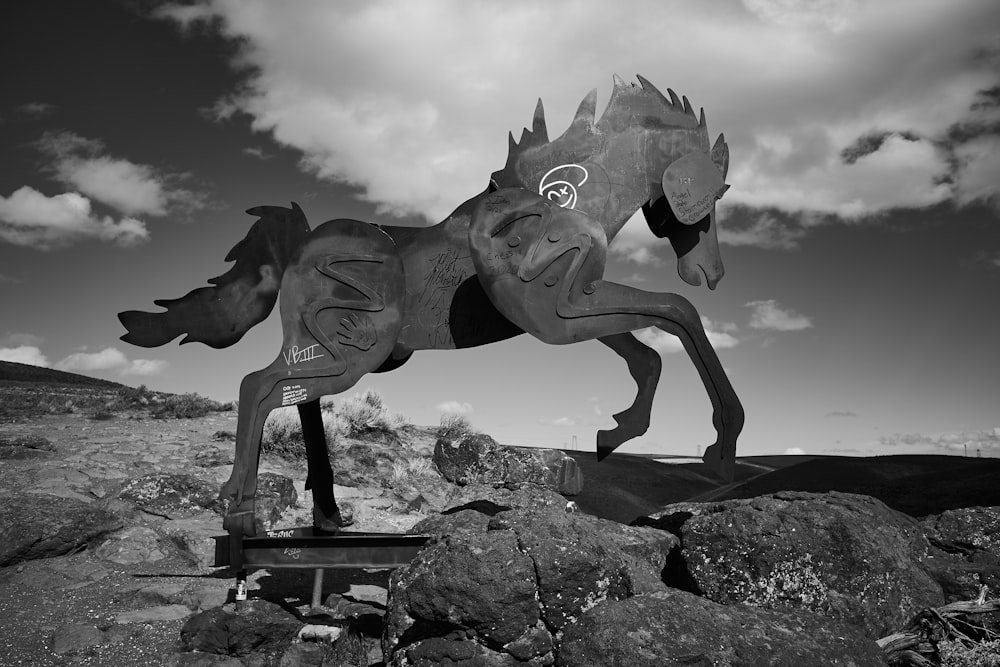 gray concrete horse statue under cloudy sky during daytime