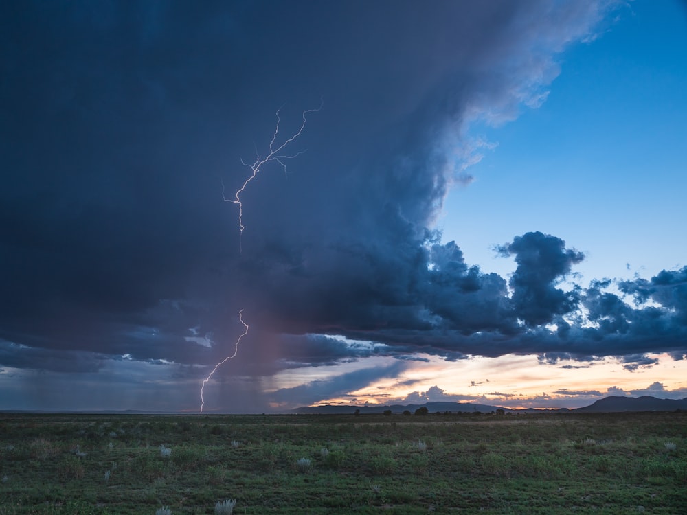 a large cloud with a lightning bolt in the sky