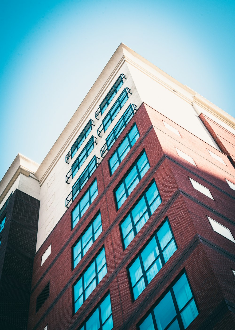 brown and white concrete building under blue sky during daytime