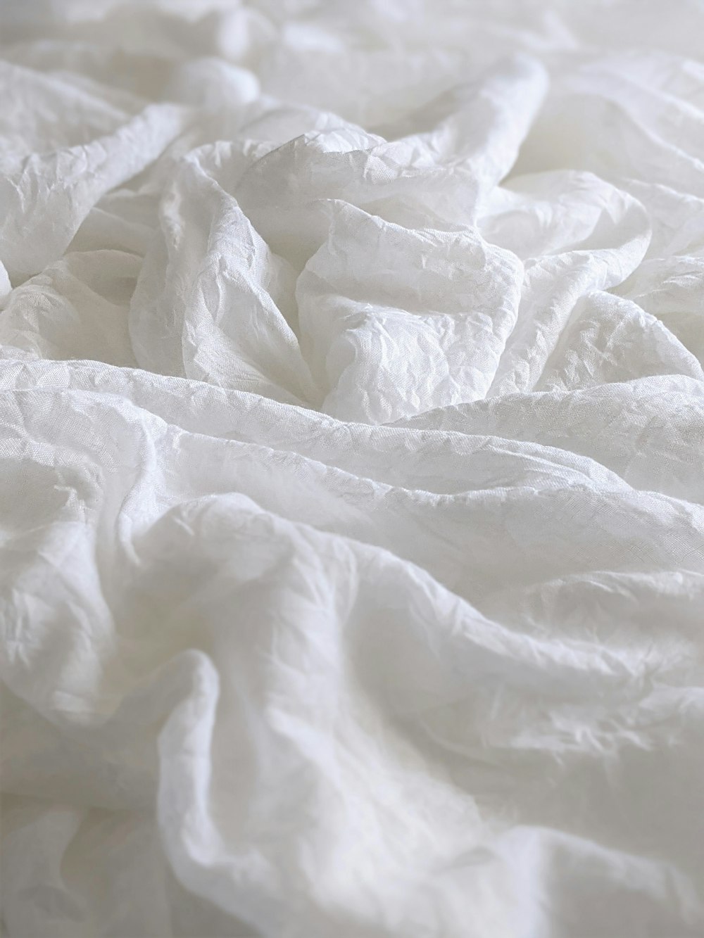 white textile on brown wooden table