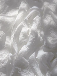 white textile on brown wooden table