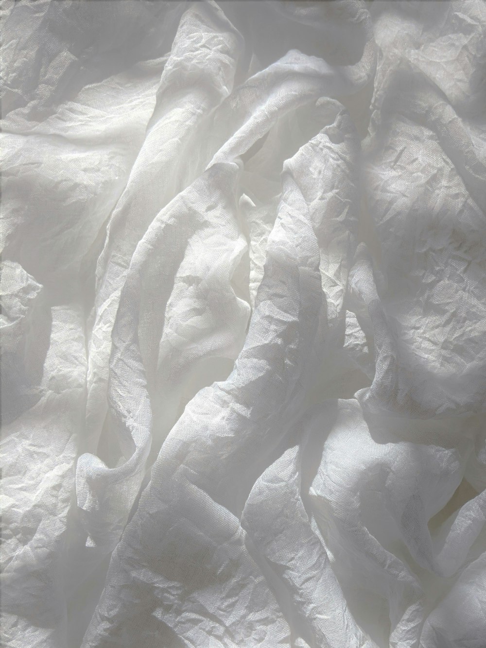 white textile on brown wooden table