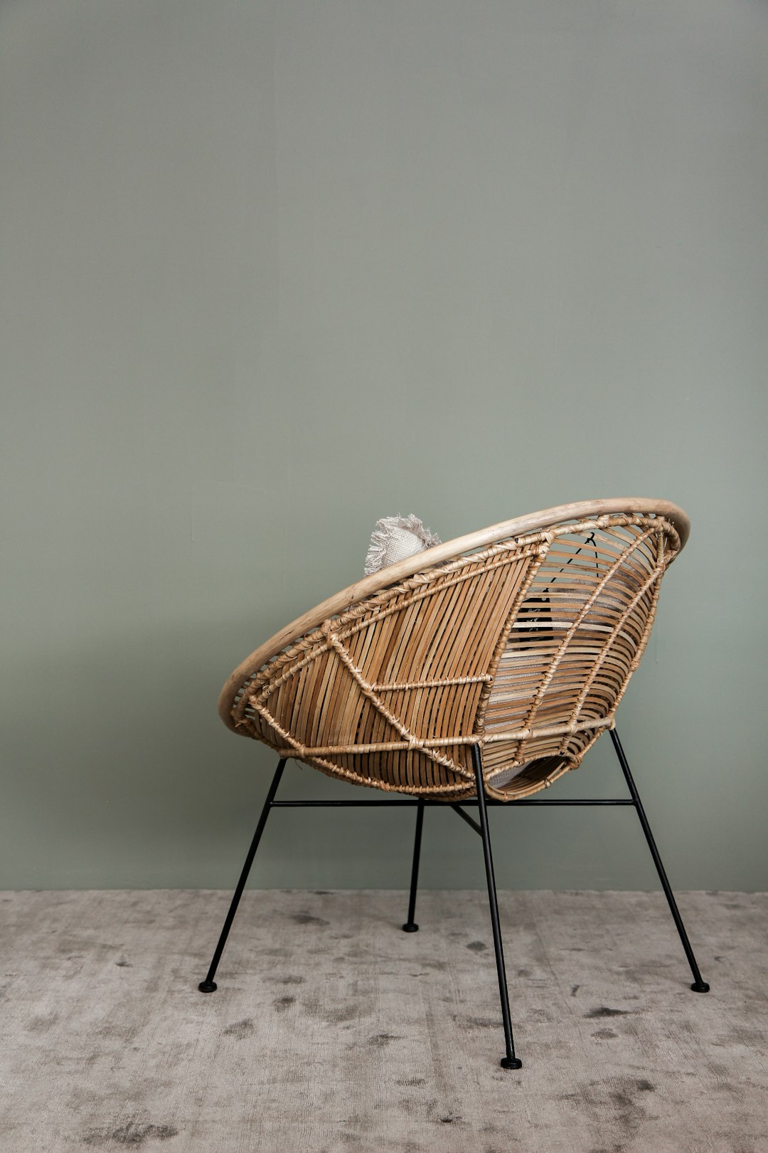 brown wicker chair on white sand