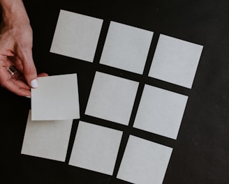 person holding white and black checkered card