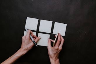 person writing on white paper