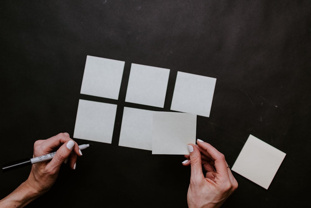 person holding white printer paper