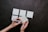Close-up of hands holding a five-star rating card against a neutral background.