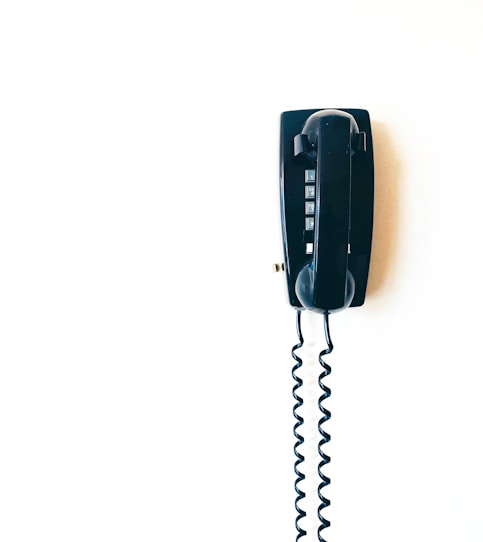 black telephone on white surface