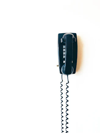 black telephone on white surface