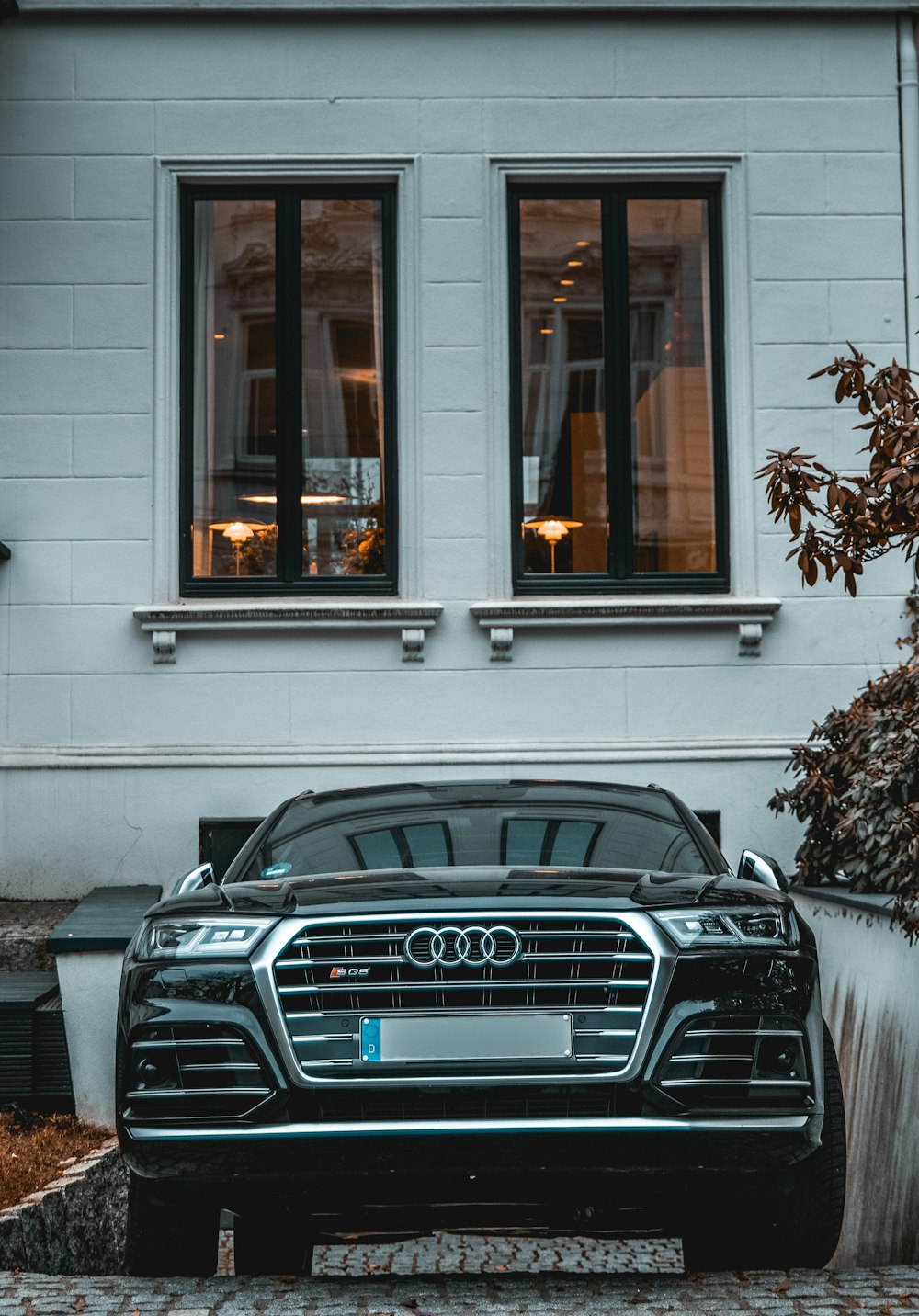 black bmw car parked beside white concrete building