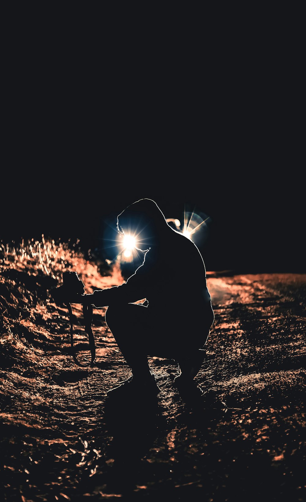 man in black jacket holding a light