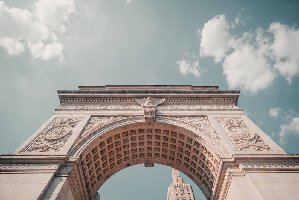 arc de triomphe under white clouds during daytime