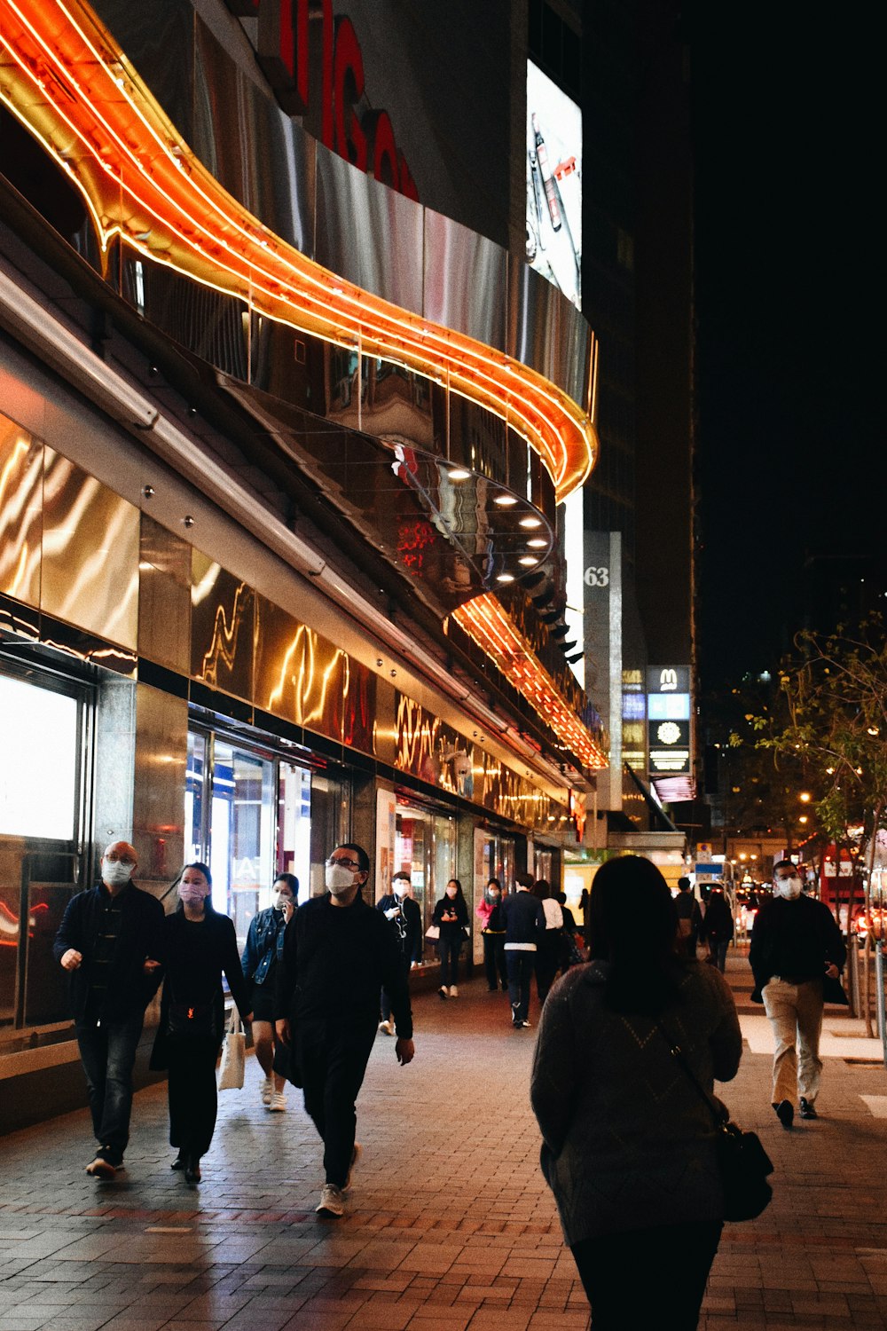 people walking on street during night time