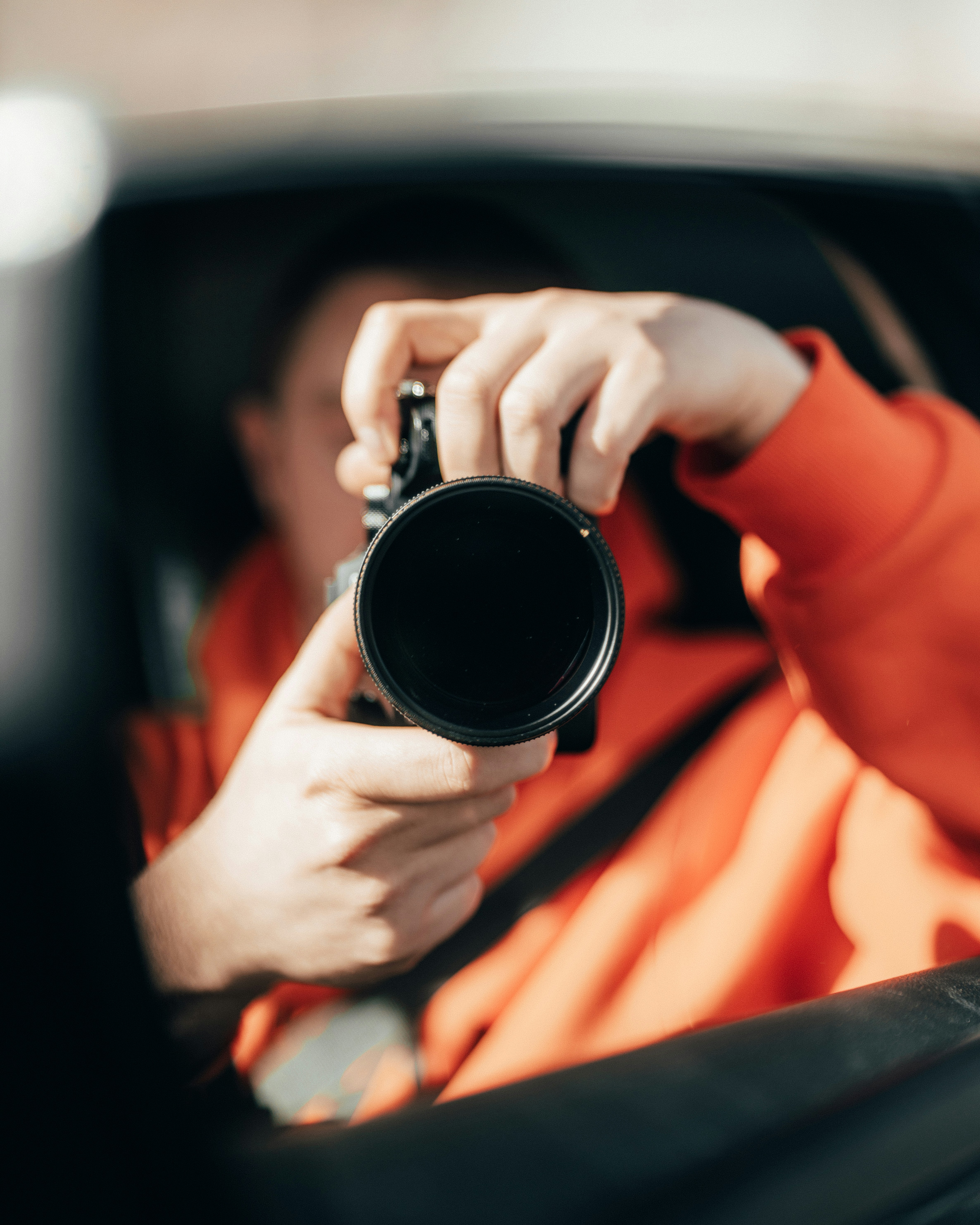 person holding black camera lens