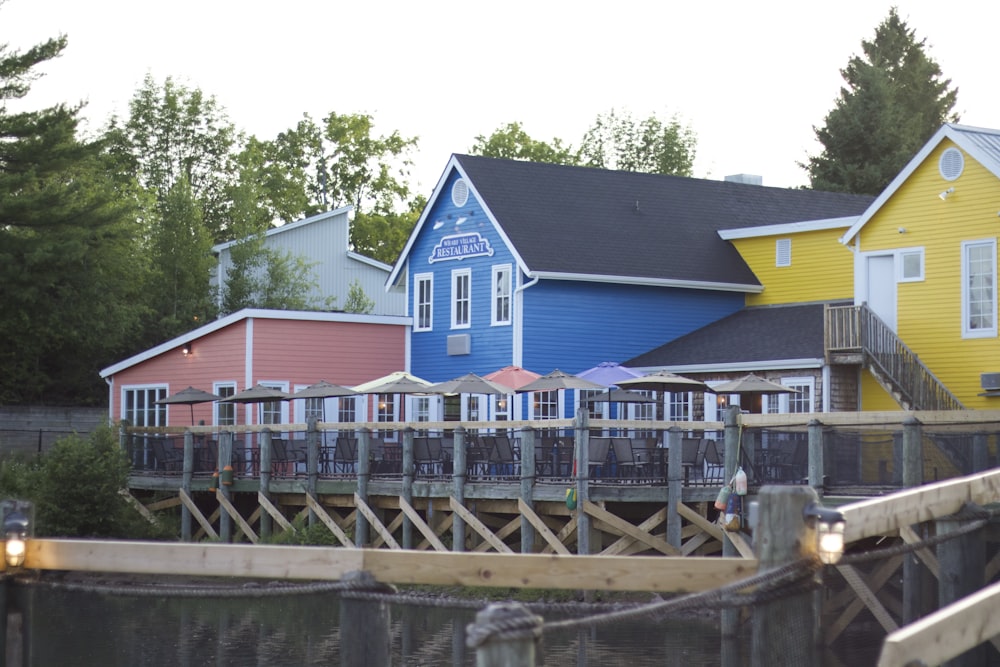 낮 동안 수역 근처의 파란색과 흰색 목조 주택