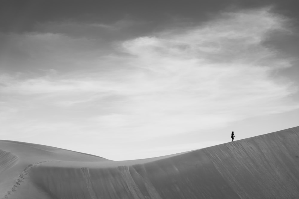 person walking on gray concrete road