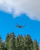 Drone capturing environmental data over a forested region with clear skies
