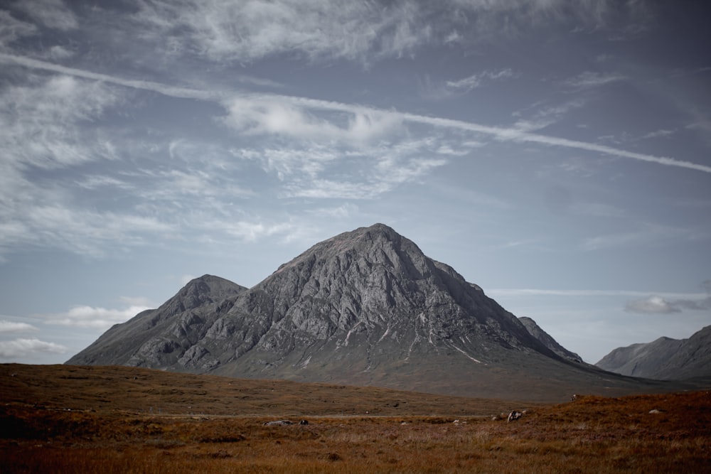 gray mountain under white clouds during daytime