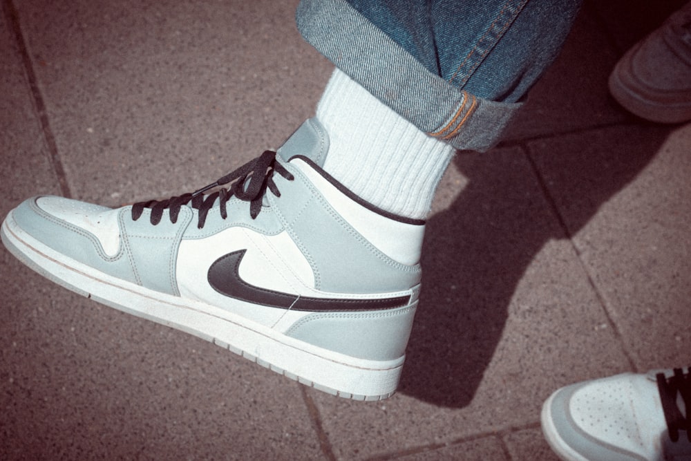 person wearing black and white nike sneaker
