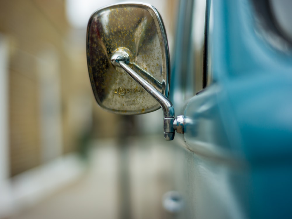 silver heart shaped pendant on blue car