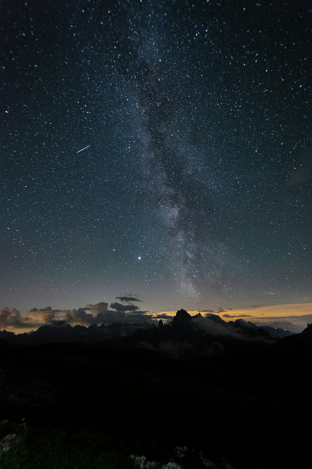 silhouette of mountains under starry night