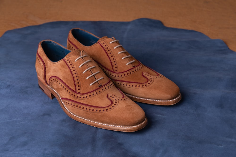 brown leather shoes on blue textile