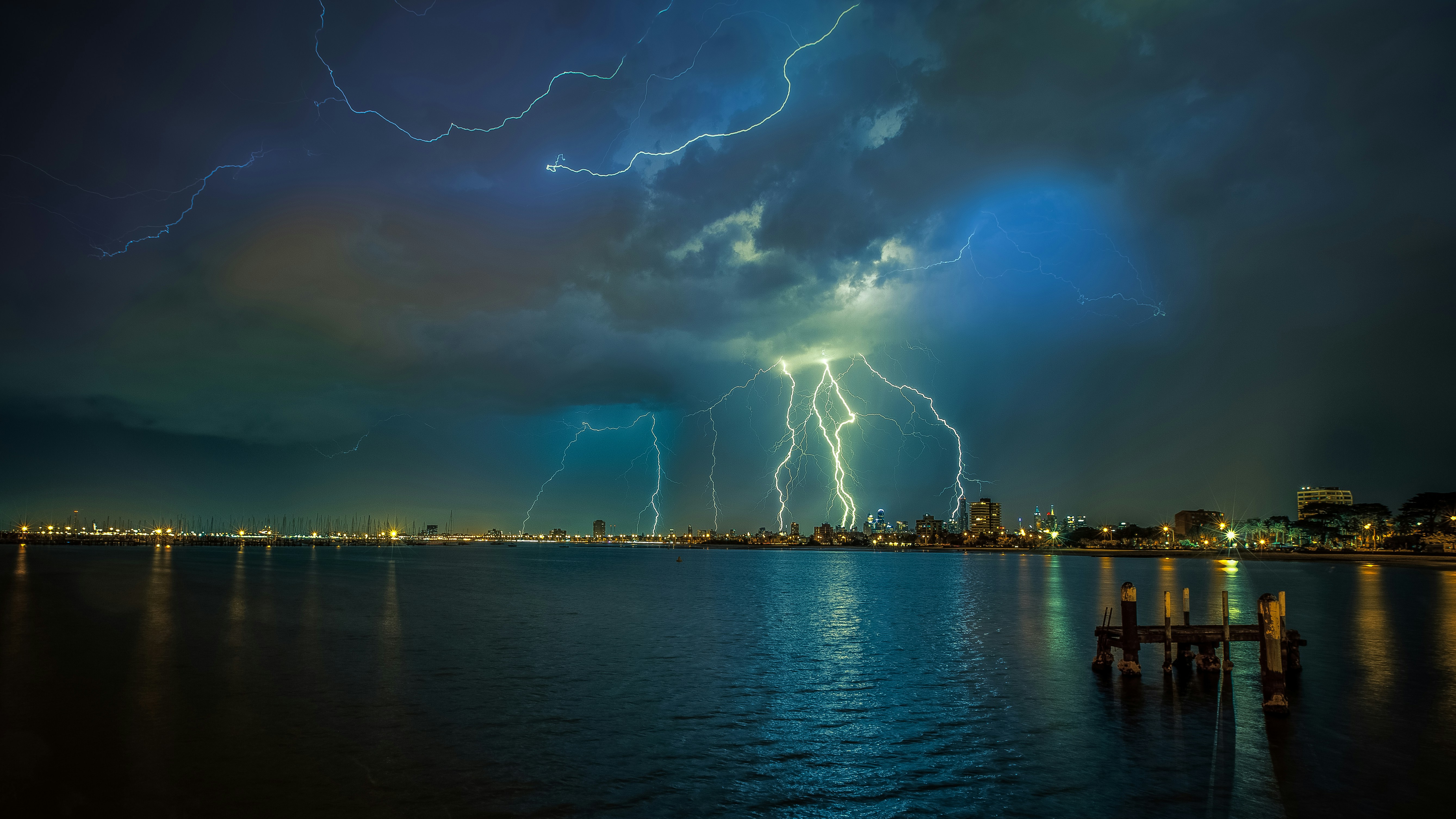 a large group of lightning strikes over a city