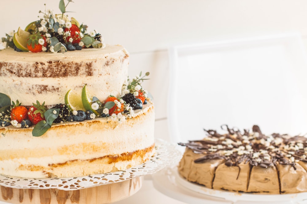 brown cake with green and red fruit on white ceramic plate