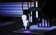 Close-up of a fiber laser engraving machine etching a photo onto a metal surface