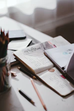 Close-up of colorful science articles and notes spread out on a desk.