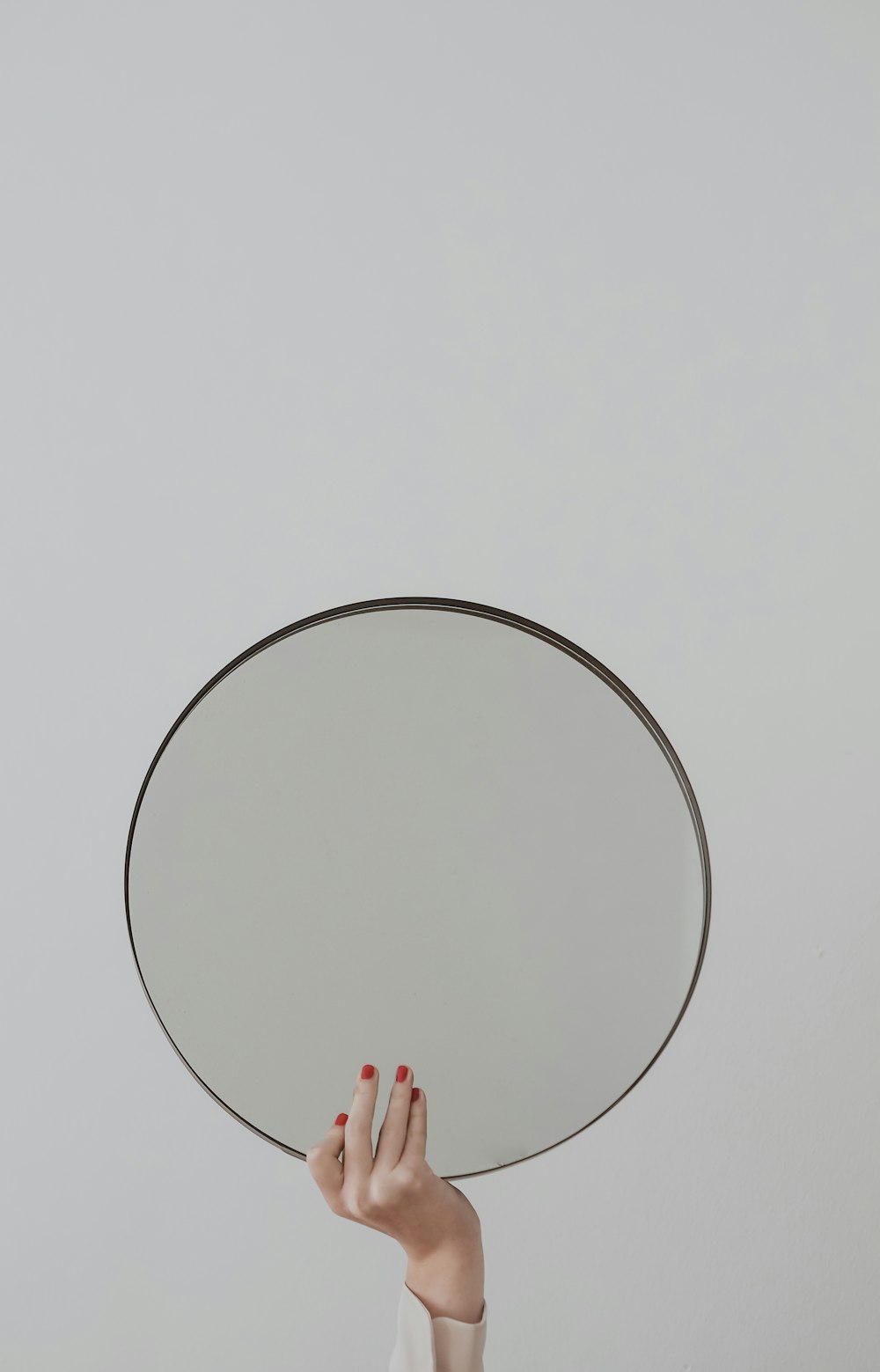 person holding round white frame