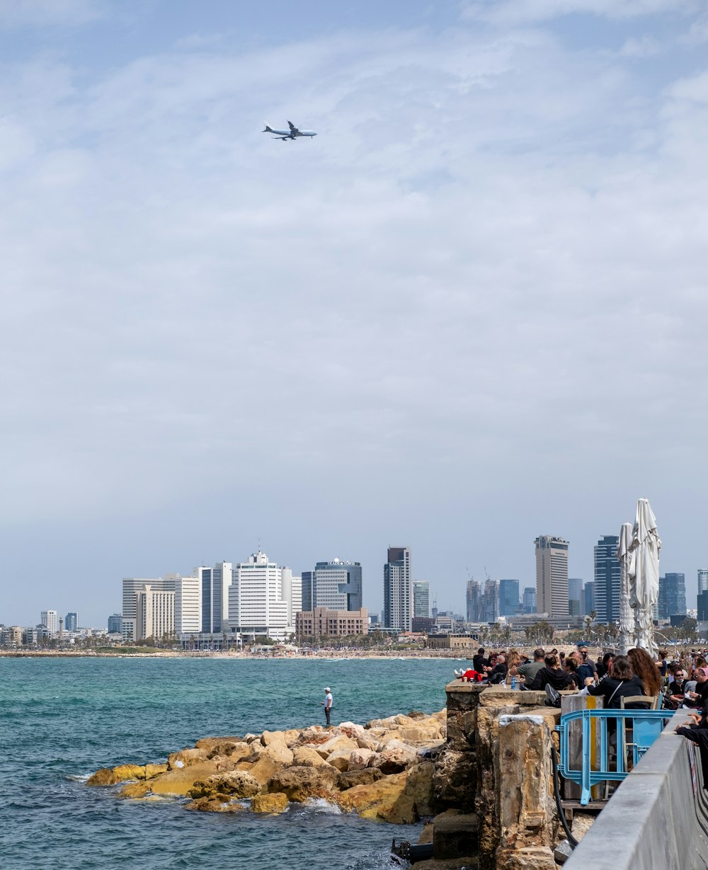 people on beach near city buildings during daytime