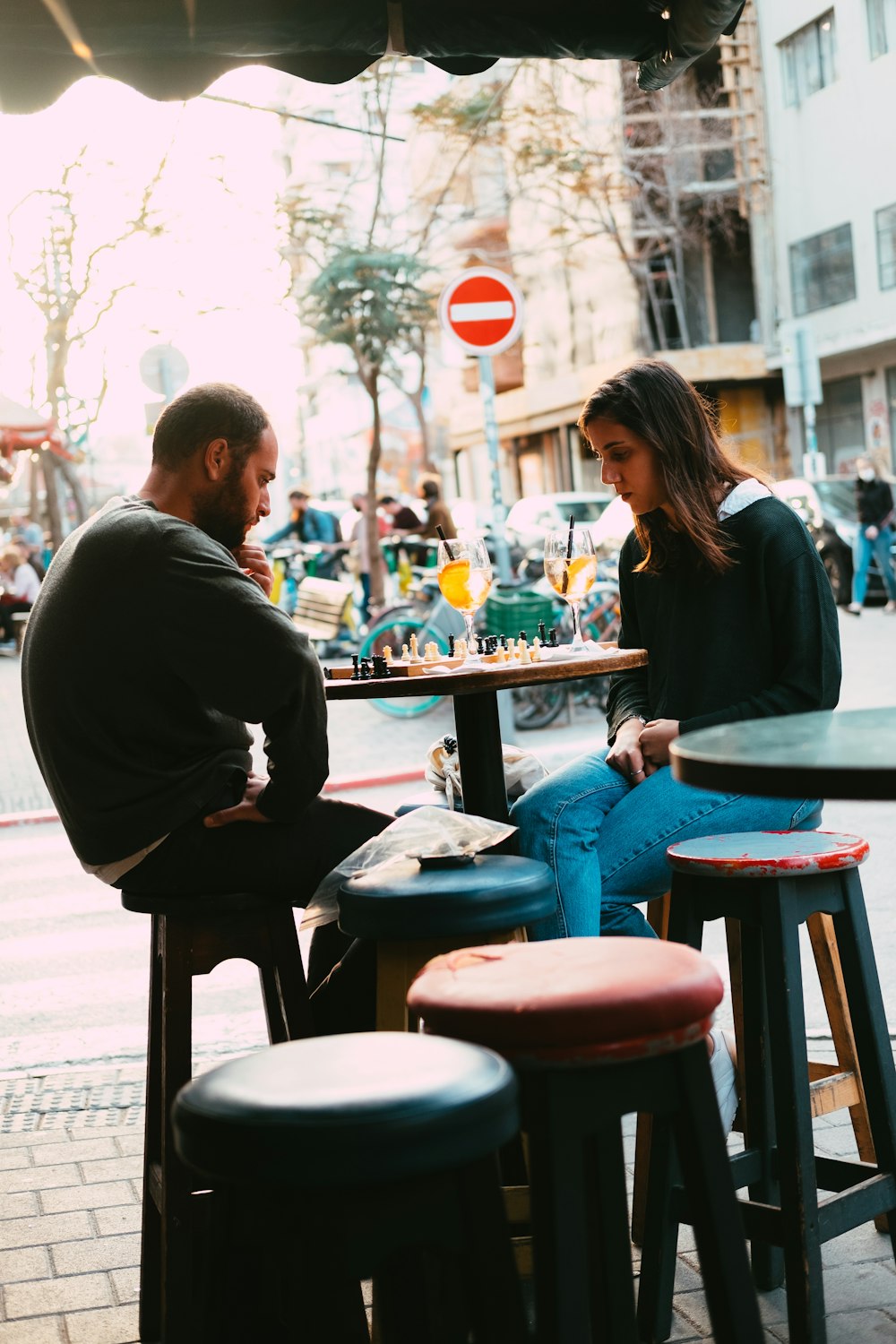 man in black long sleeve shirt standing beside woman in blue long sleeve shirt